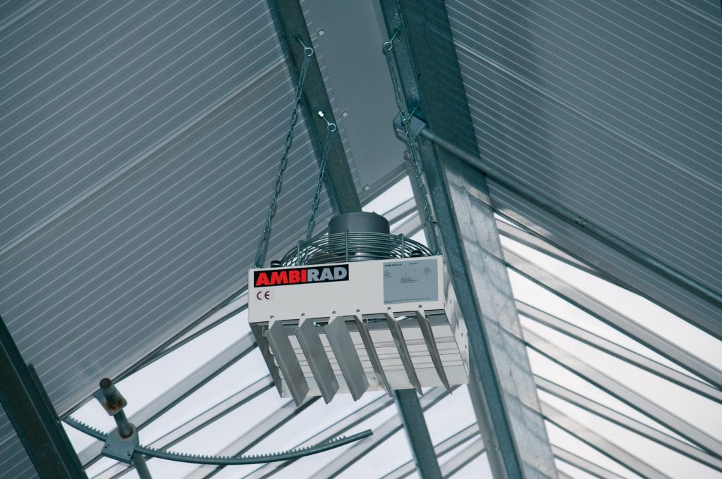 Commercial warm air heater unit mounted on industrial ceiling
